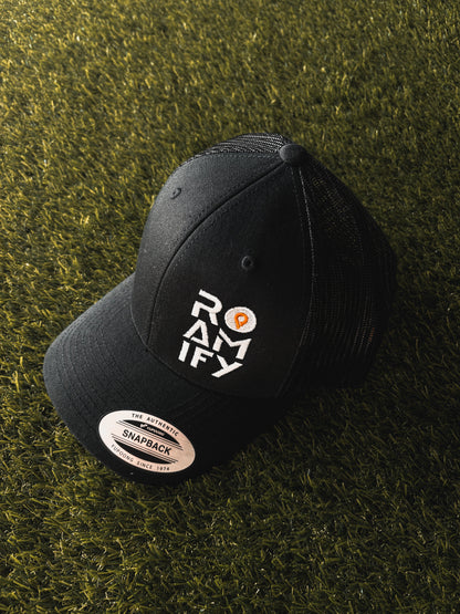 Black cap with 'ROAMIFY' logo on a grassy background